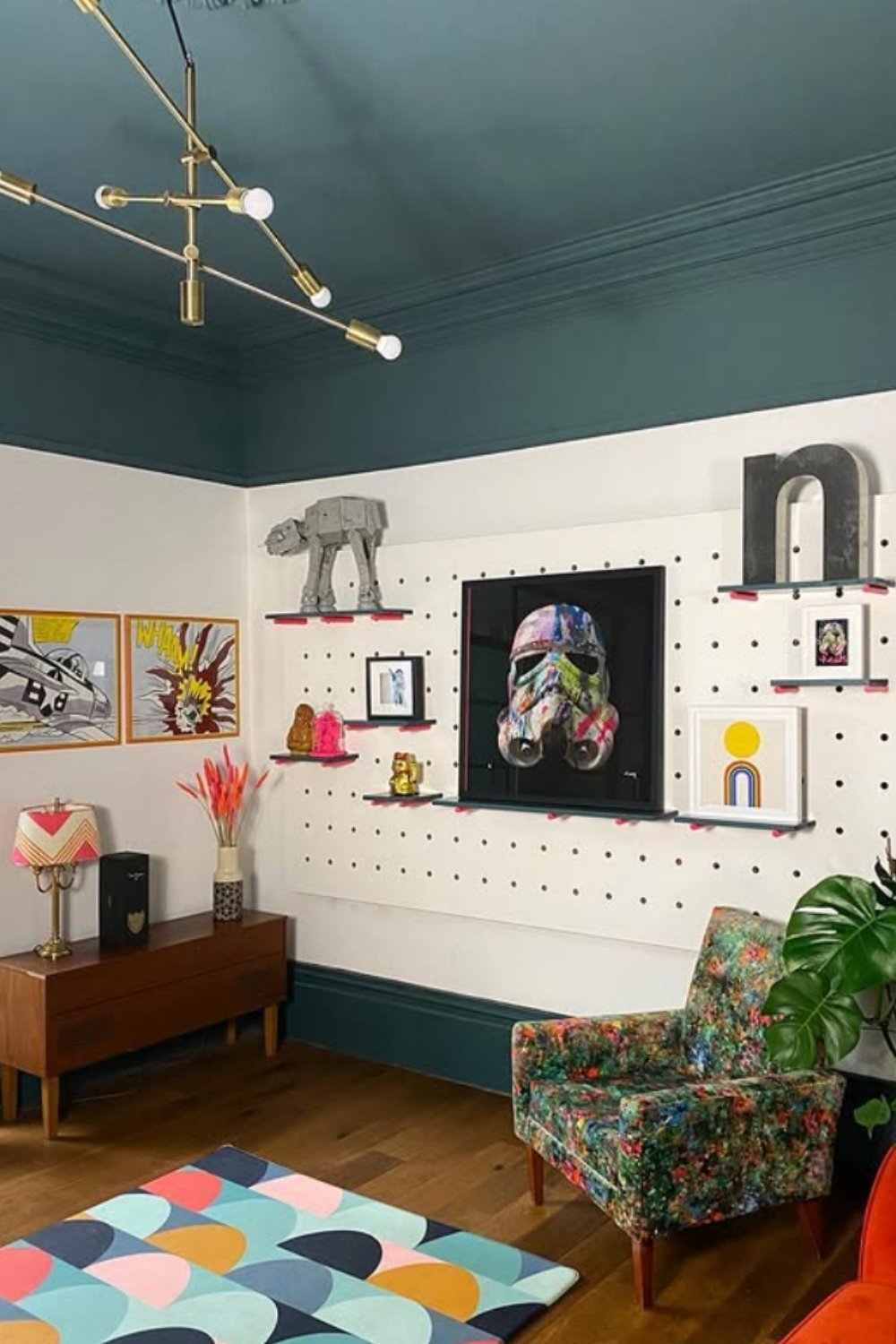 Gallery wall mixing playful color pops with a dramatic central portrait.
