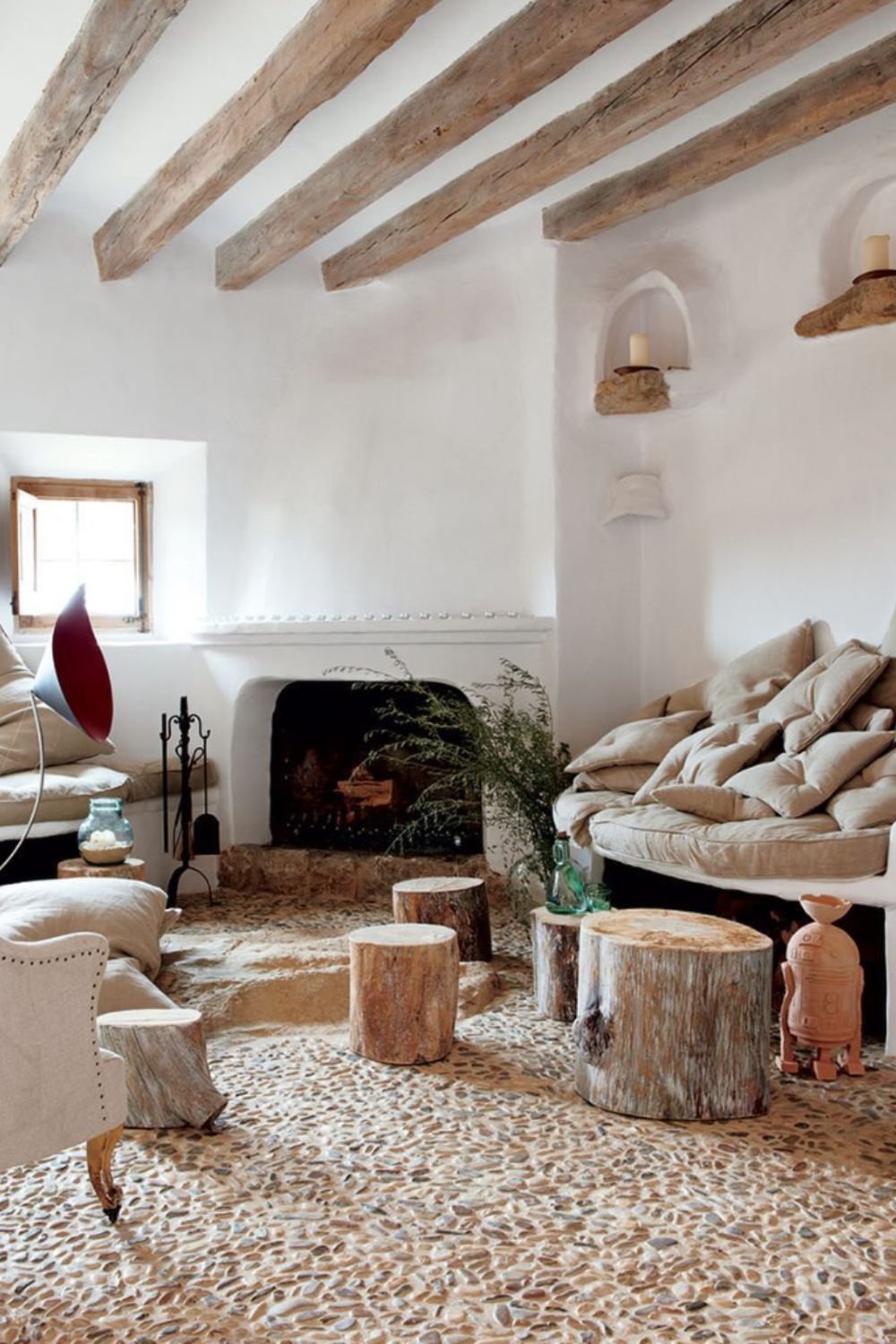 Rustic living room with exposed beams, stone fireplace, and earthy textures – tuscan style home interior design
