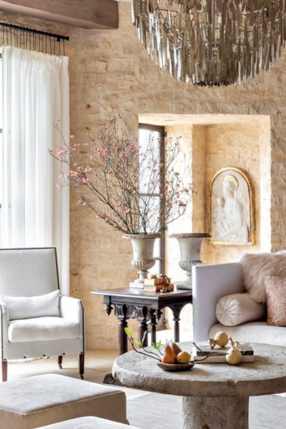 Bright lounge with stone walls and elegant armchairs
