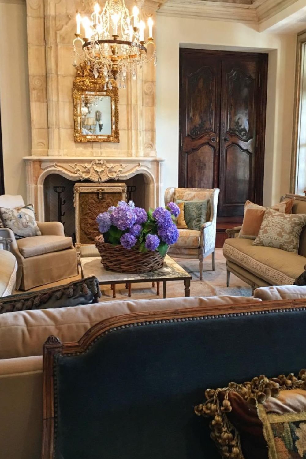 Luxurious living room with chandelier, fireplace, and ornate furniture