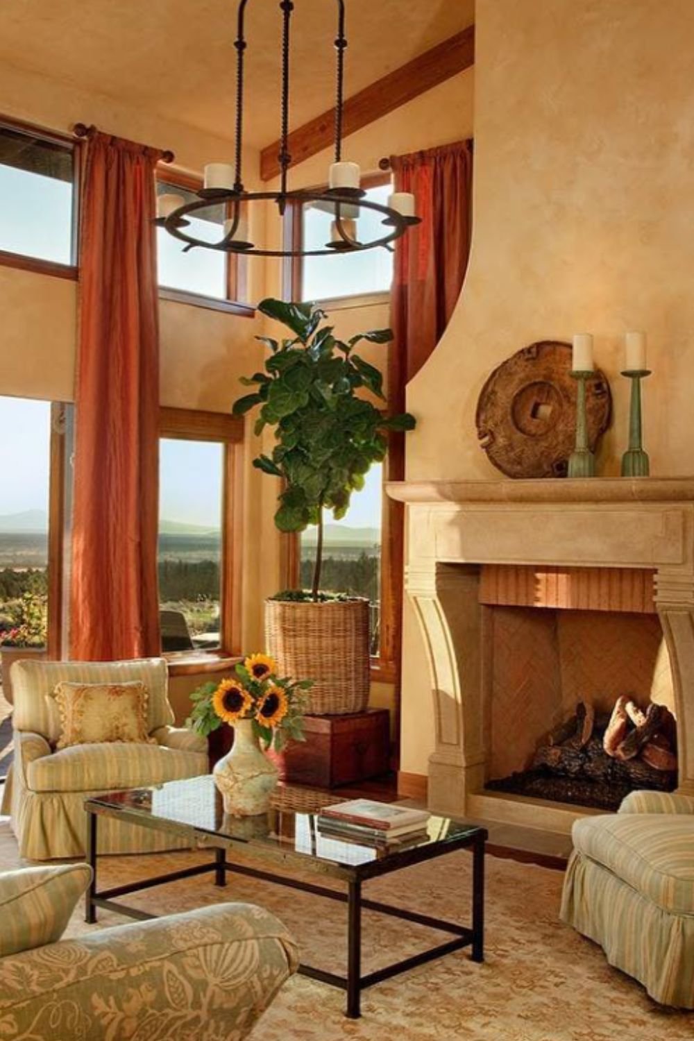 Living room with high ceilings, tall windows, and stone fireplace