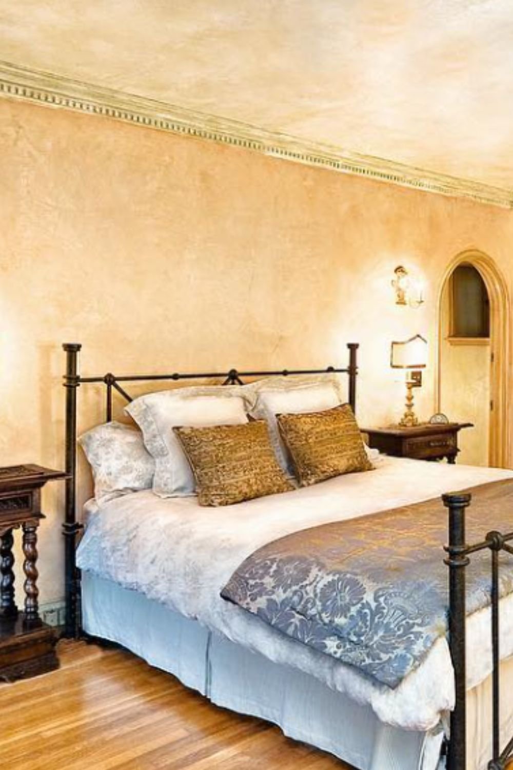 Inviting tuscan bedroom with wrought iron bed, warm walls, and natural wooden flooring – tuscan style home interior design