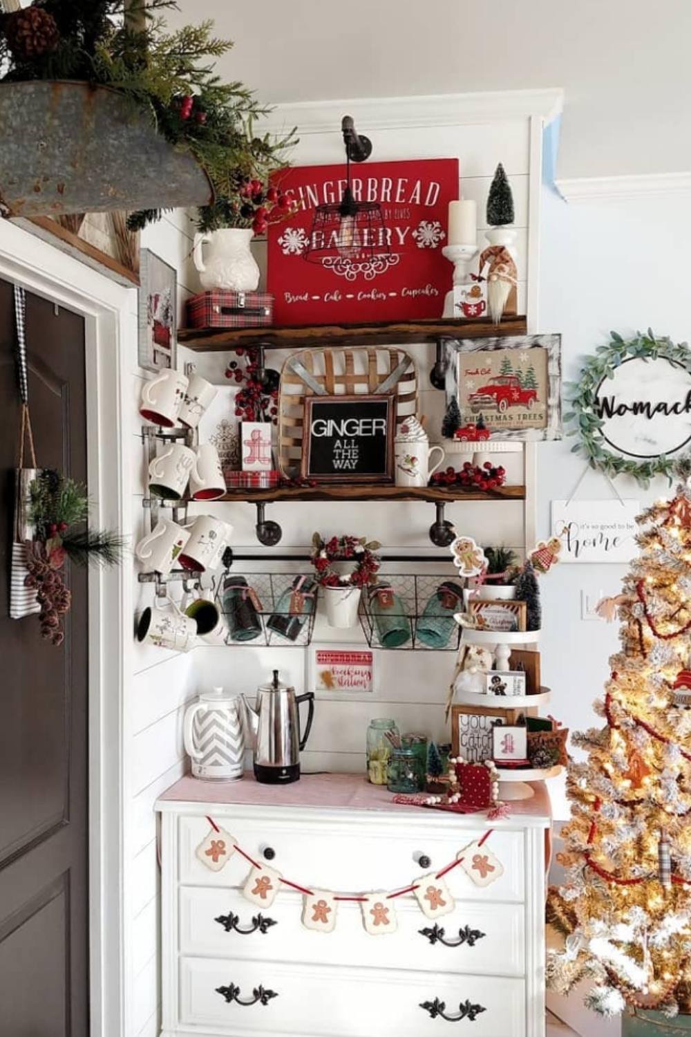 Festive white coffee bar with holiday lights, red accents, and mugs.