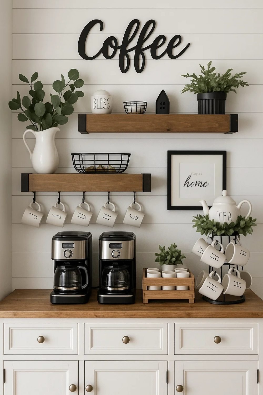 White coffee bar with oversized “Coffee” wall letters and greenery.