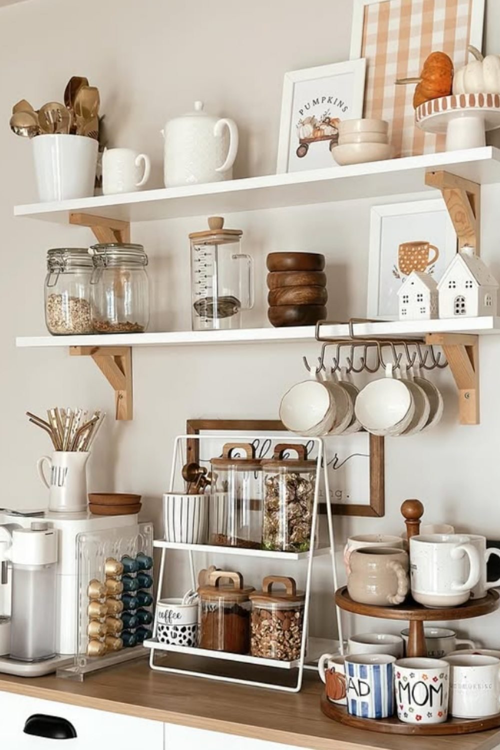 White coffee nook with jars, tiered stand, mugs, and layered storage.