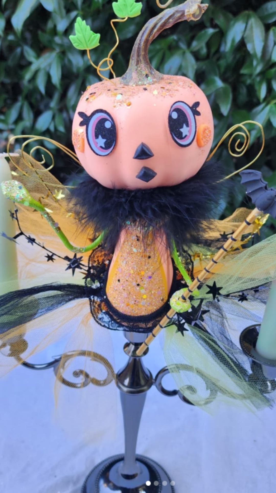 Whimsical pumpkin-headed fairy figurine centerpiece with wings and sparkly details