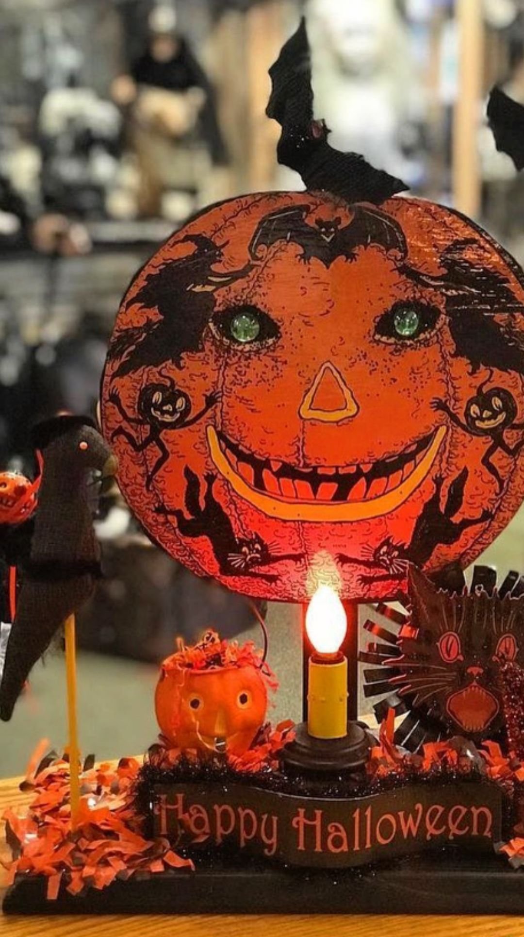 Vintage Halloween centerpiece with glowing jack-o’-lantern face and Happy Halloween sign