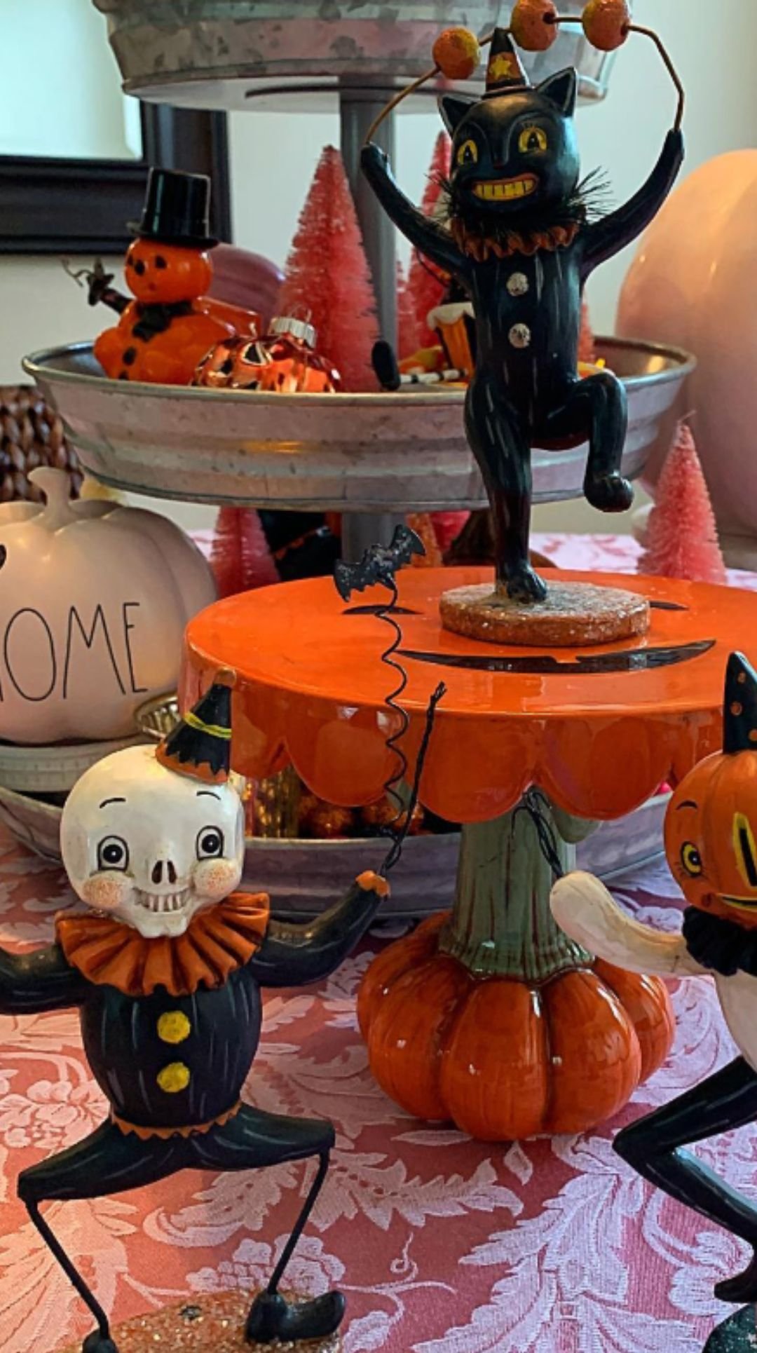 Whimsical Halloween centerpiece with vintage-style skeleton, pumpkin, and black cat figurines