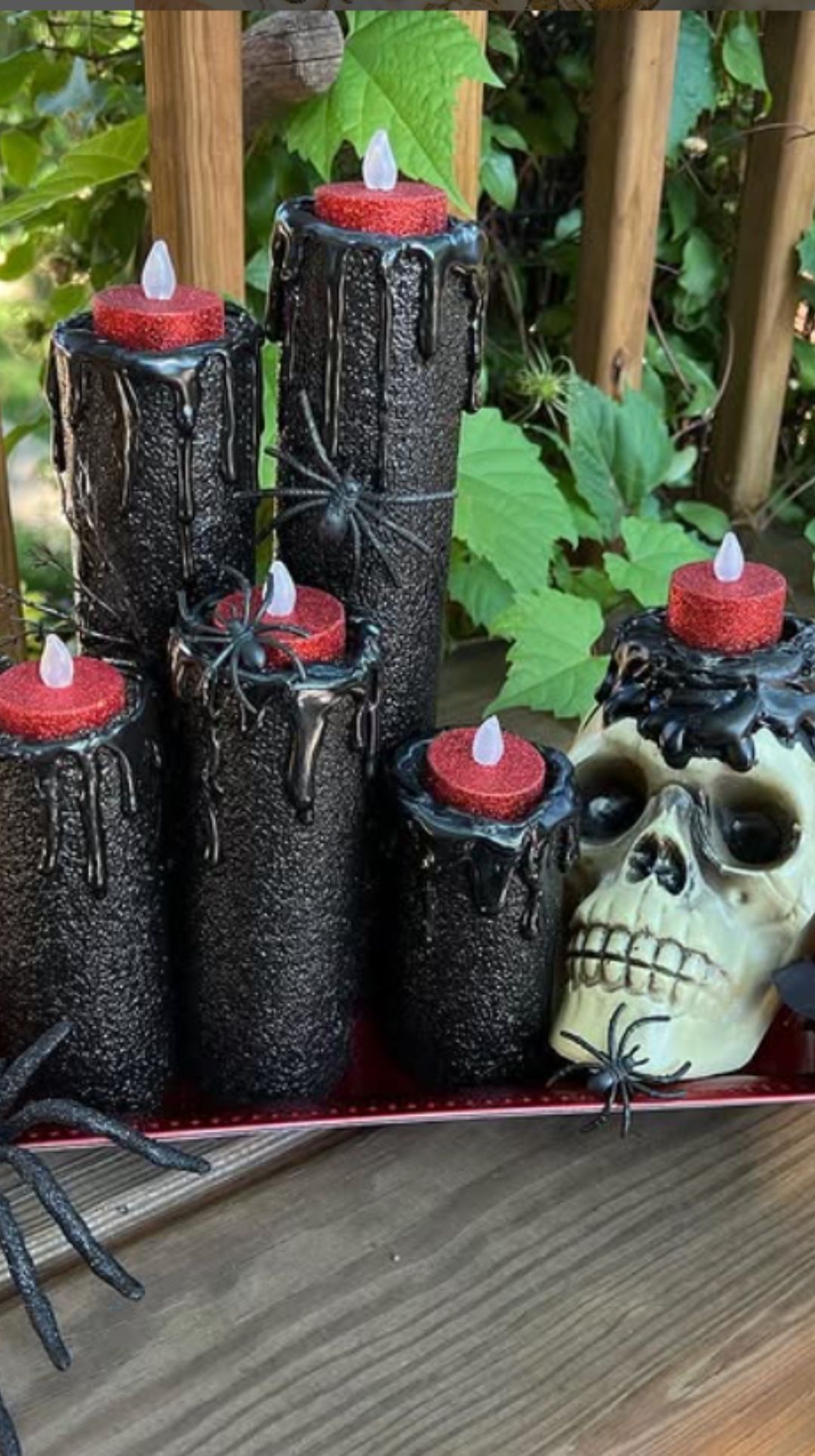 Halloween centerpiece with tall black drip candles and skull decoration