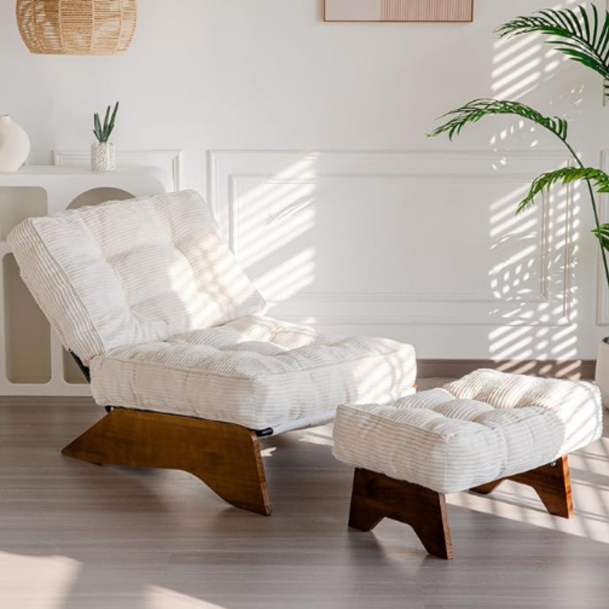 Adjustable lounge chair with footrest in textured beige fabric and wooden base.