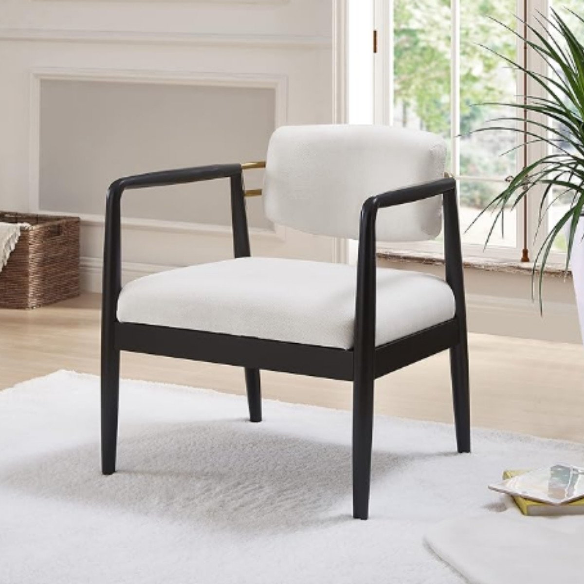 Japandi accent chair with a slim black wood frame and ivory cushioned seat.