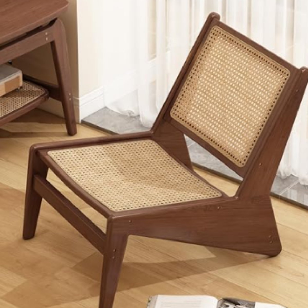 Low-profile wooden rattan lounge chair with angled frame and woven backrest.