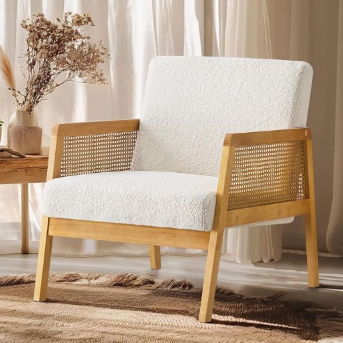 Boucle accent chair with rattan side panels and a natural wood frame.
