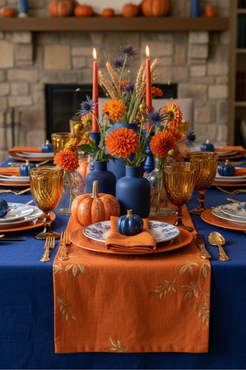 Elegant Thanksgiving table with orange runner, navy accents, and pumpkin floral centerpiece.