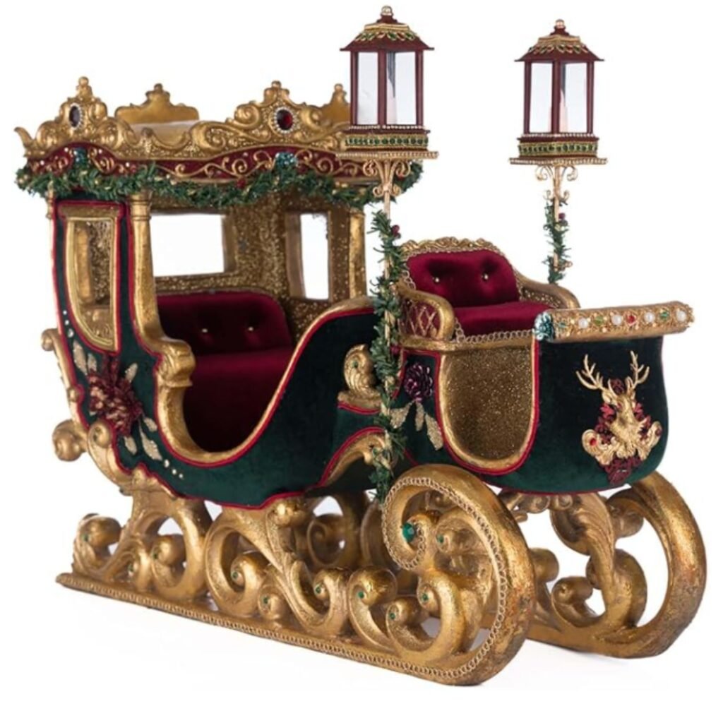 Luxury Christmas sleigh décor by Katherine’s Collection, featuring green velvet upholstery, jewelled embellishments, gold leaf runners, and ornate lanterns.