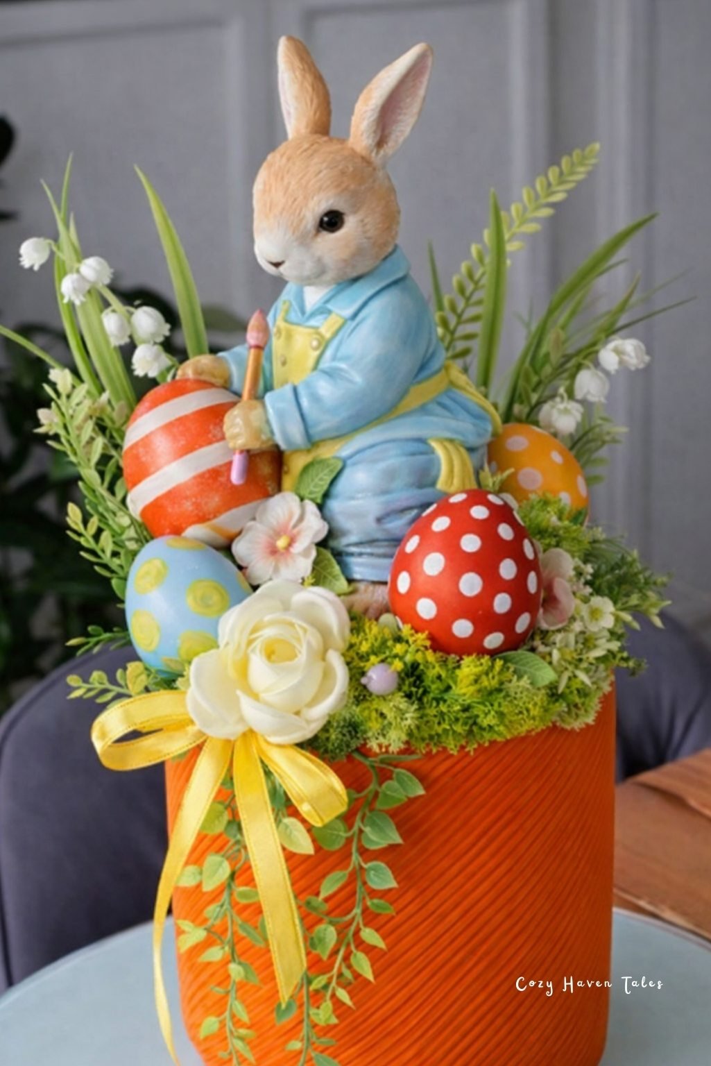 Large bunny figurine centerpiece surrounded by roses and colorful Easter eggs.