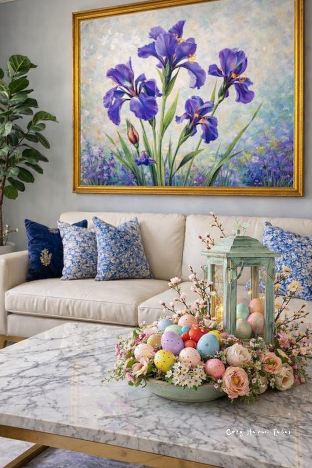 Coffee table centerpiece with lantern, pastel eggs, and spring florals beneath framed artwork.