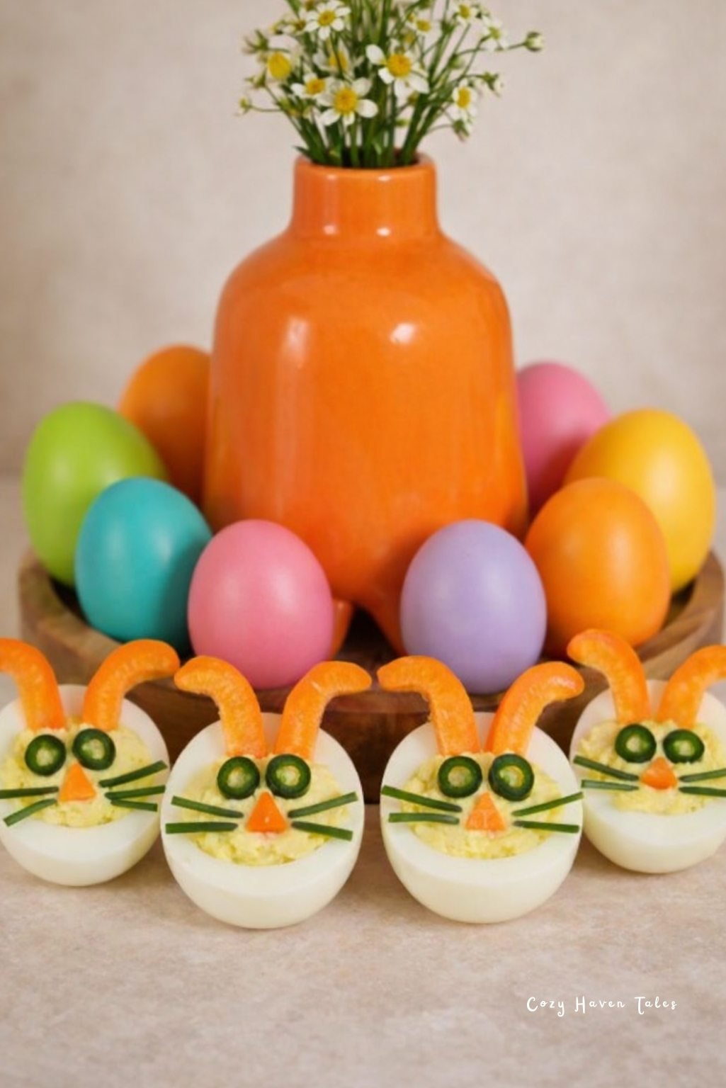 Bright orange vase with white flowers and painted eggs styled as vibrant easter table decor.