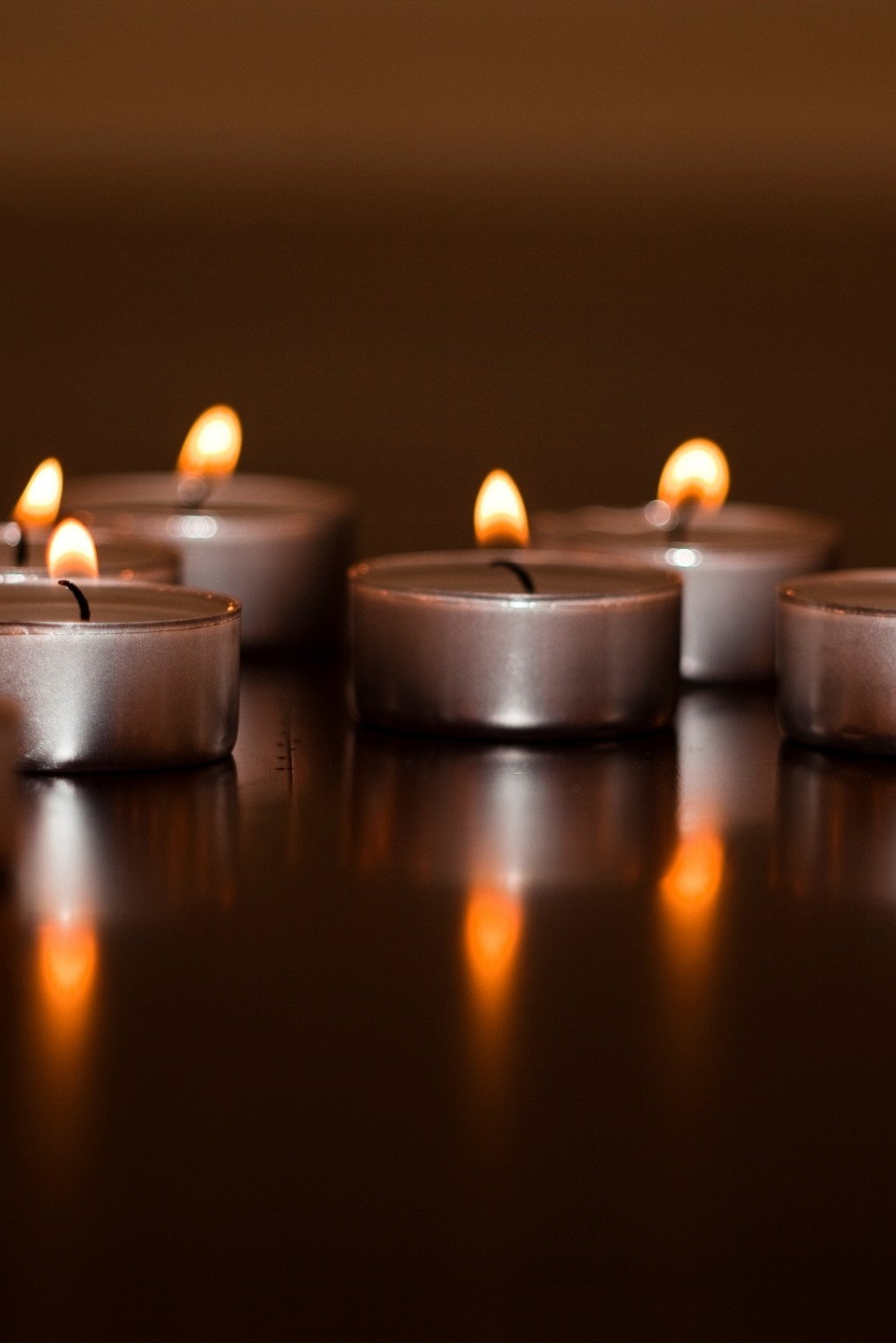 Relaxing corner at home styled with lit candles and soft ambient lighting to create a calm and peaceful evening atmosphere