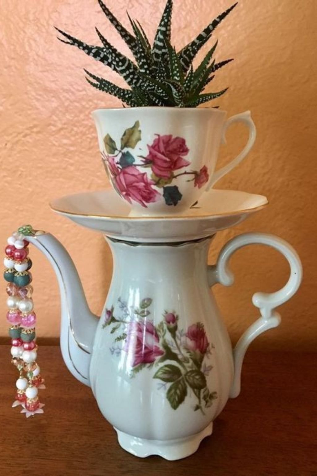 stacked vintage teacups with small succulent plants