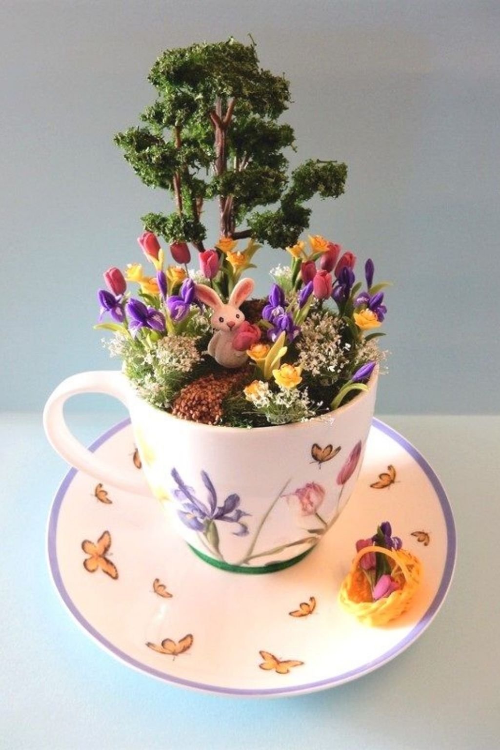 oversized teacup planter with bonsai-style plant