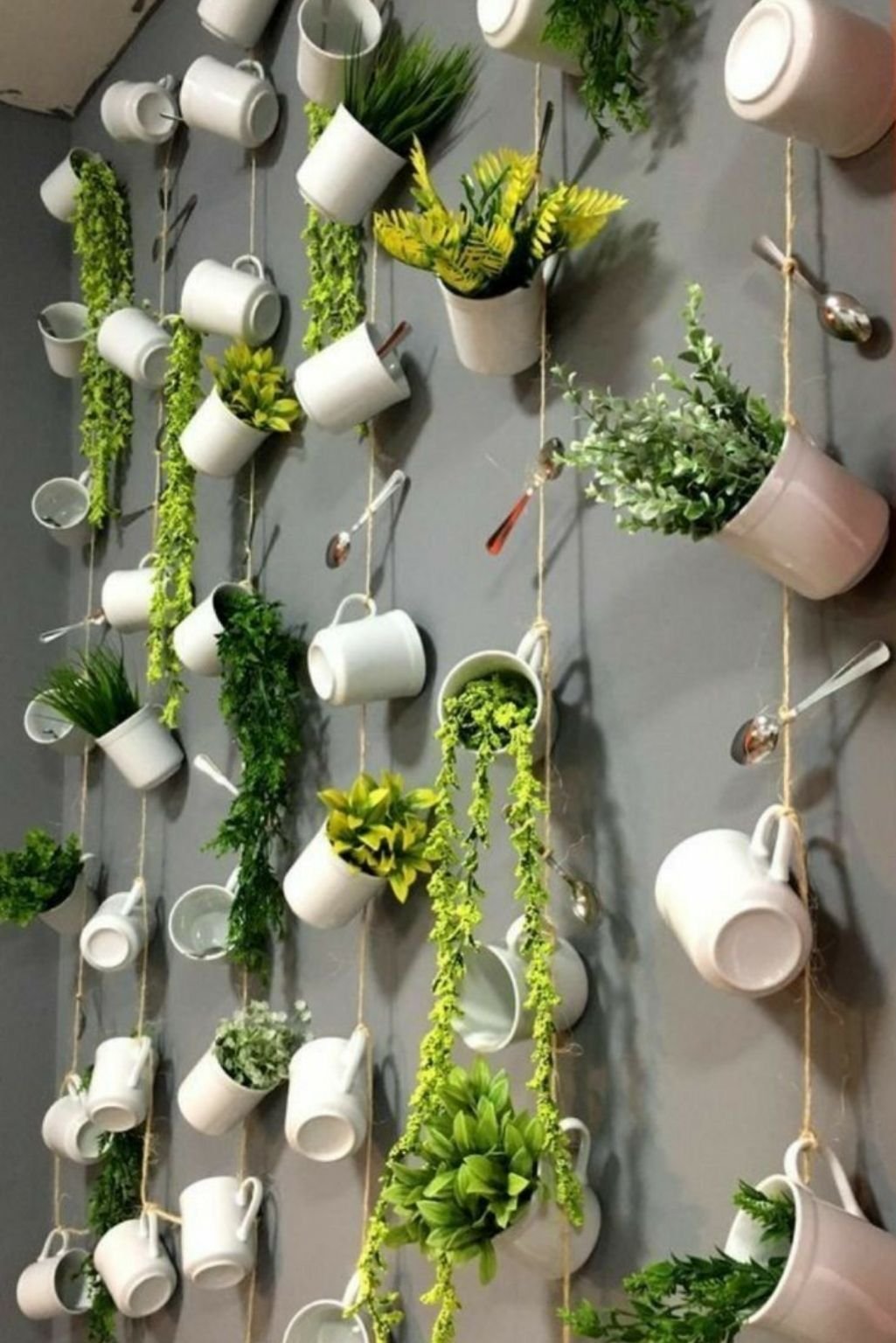 vertical wall garden made with hanging teacups