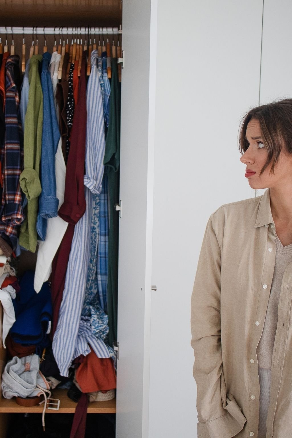 A crowded closet where clothes are tightly packed, a clear sign among the 7 red flags your home has too much stuff