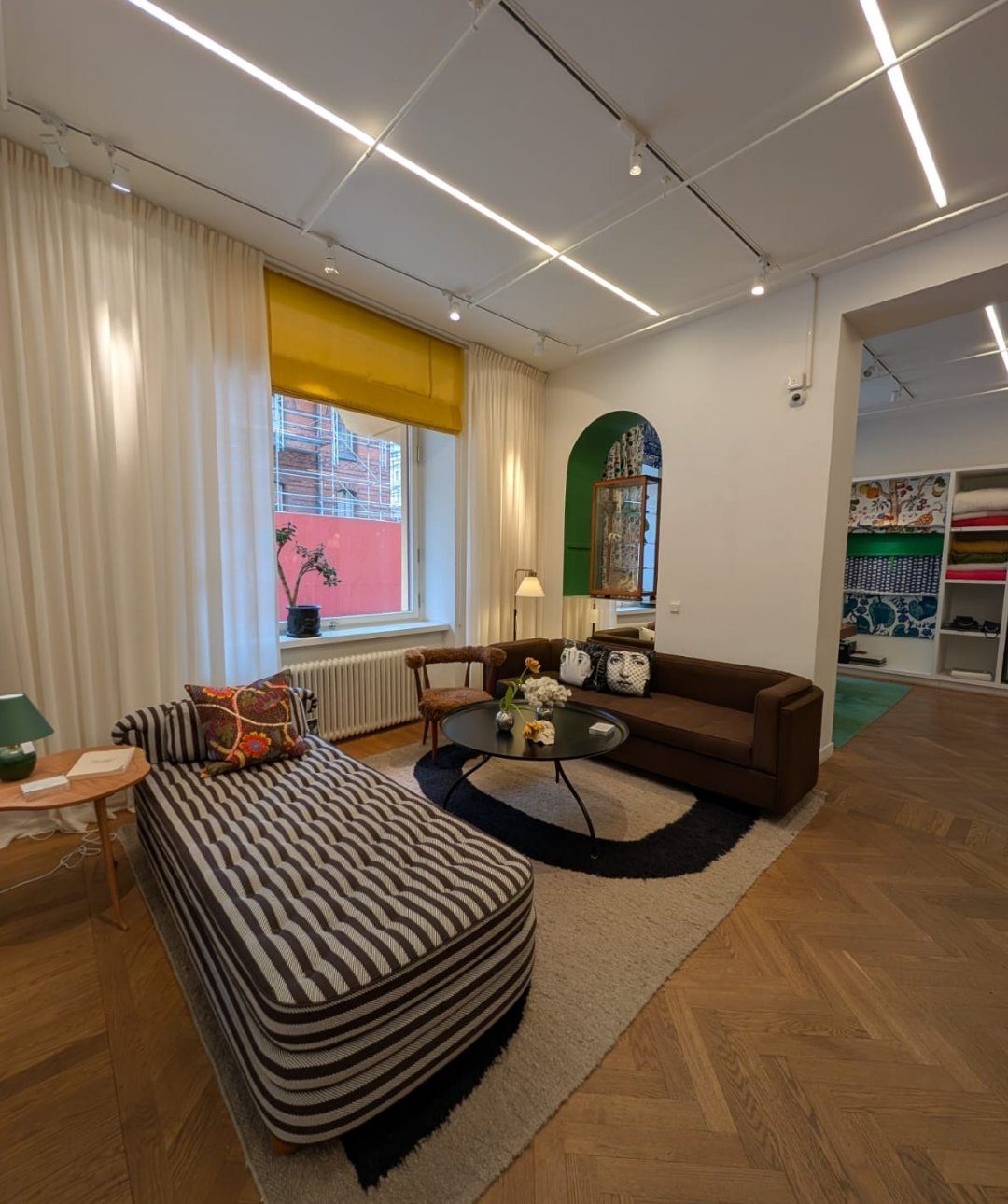 Scandinavian living room with neutral tones and colorful accents at Svenskt Tenn