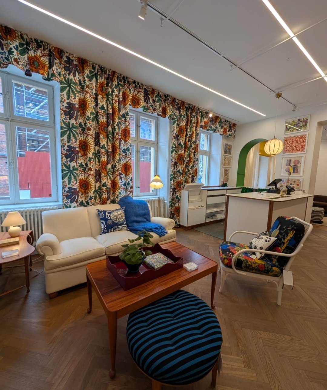 Eclectic Scandinavian living room with colorful curtains and layered decor