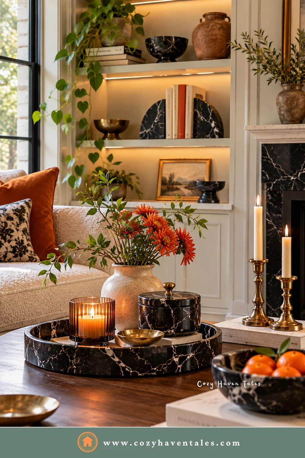 Small black marble decor on a coffee table, with a round tray, a lidded box, a candle, and brass candlesticks