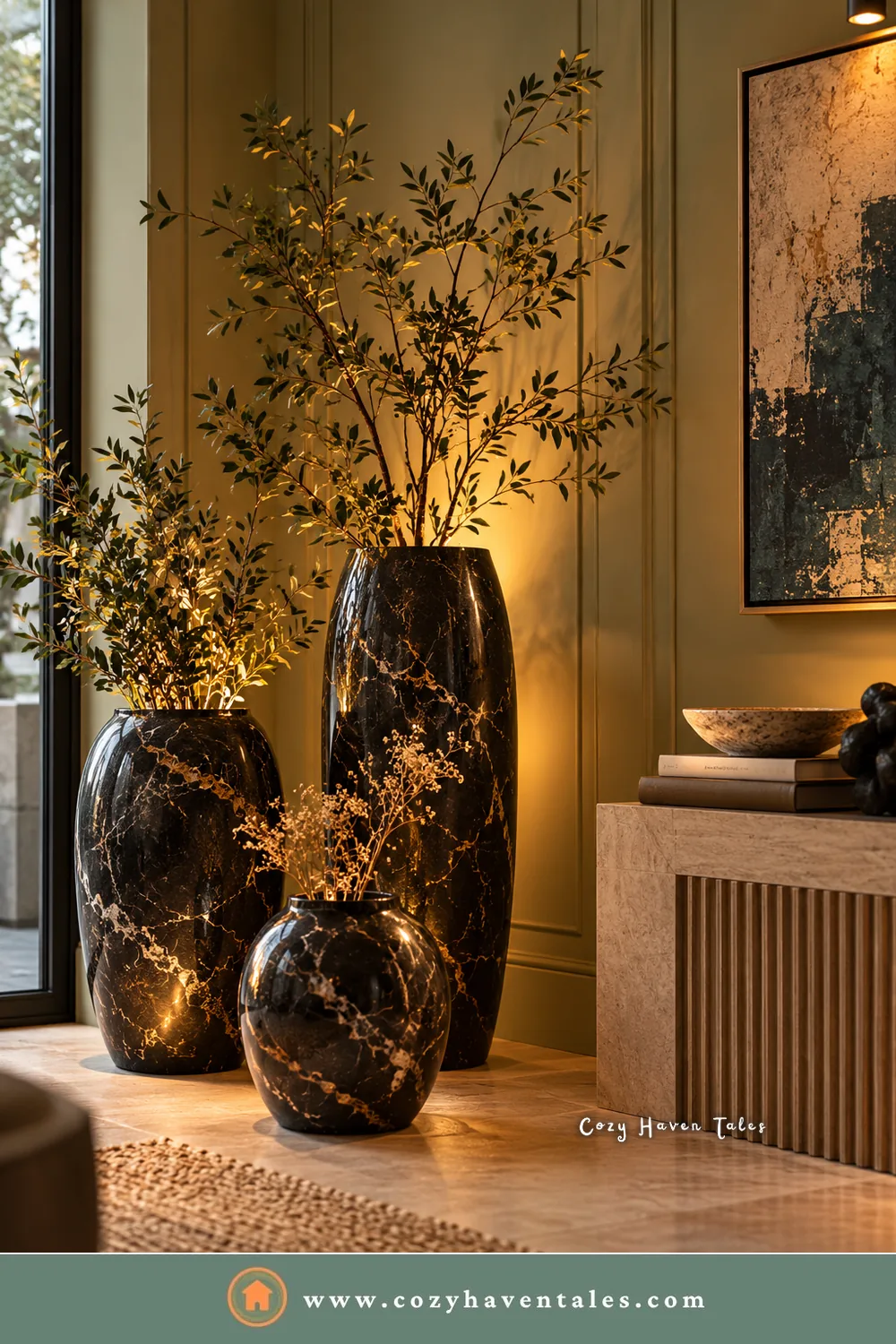 Black marble decor in an entry corner, with three black marble vases holding olive branches beside a fluted console