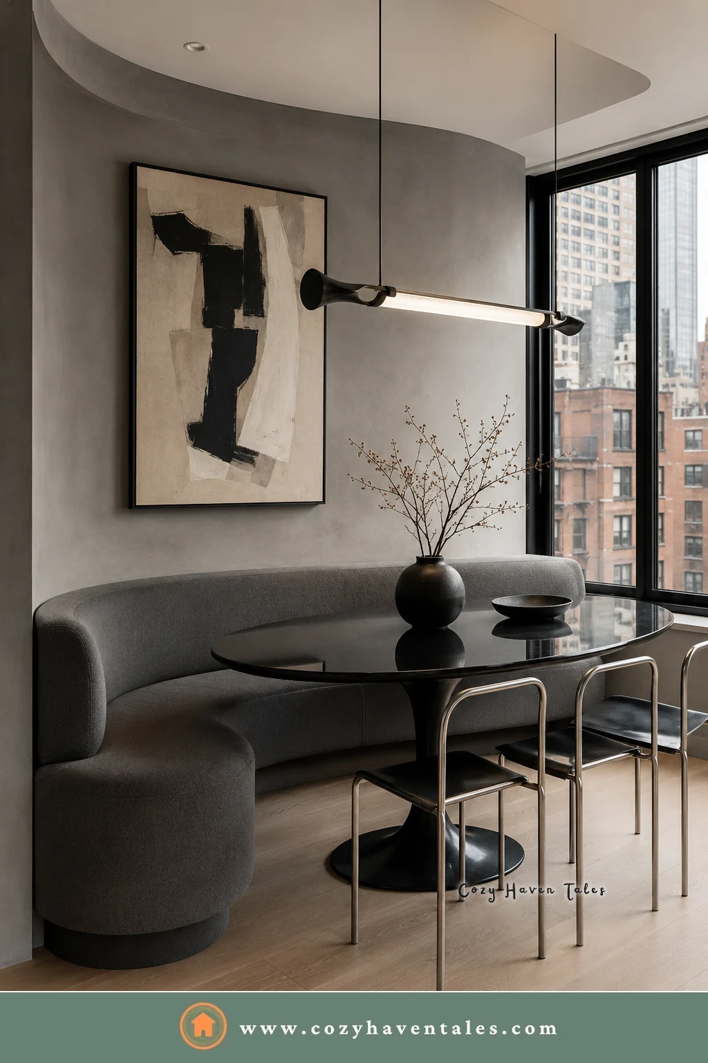 Gray curved banquette seating with a black tulip table and chrome chairs in a high-rise apartment