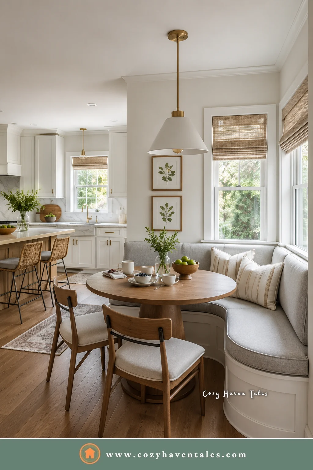 Curved banquette seating with a painted white base off an open kitchen with a round wood table