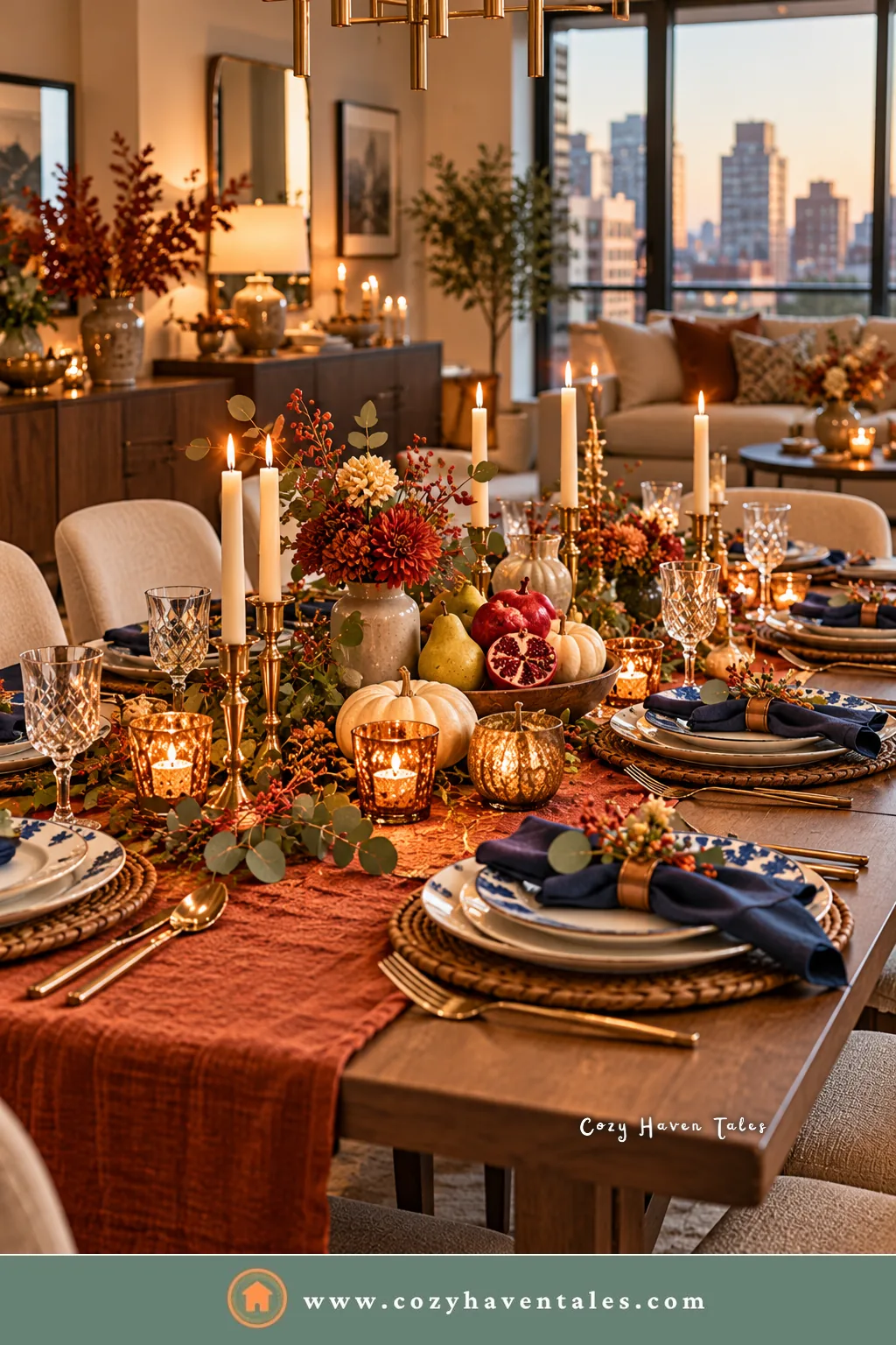 Thanksgiving table with a rust linen runner, navy napkins in brass rings, pears, pomegranates, and candles in a city apartment dining room