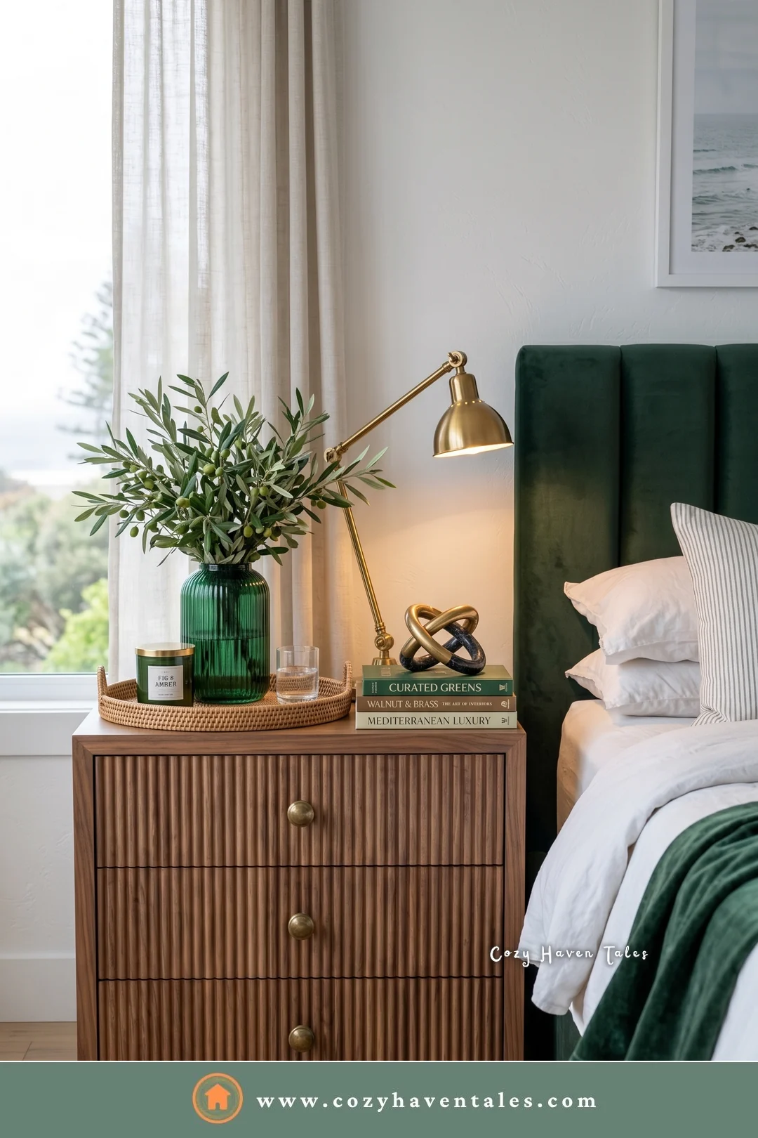 Reeded walnut bedside nightstand with three drawers, a brass lamp, and plants beside a green velvet bed