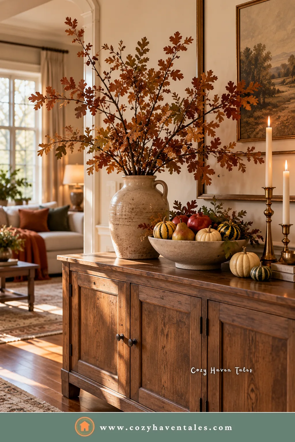 Wood sideboard with foraged fall branches in a stoneware jug, a bowl of pears and apples, small pumpkins, and brass candlesticks